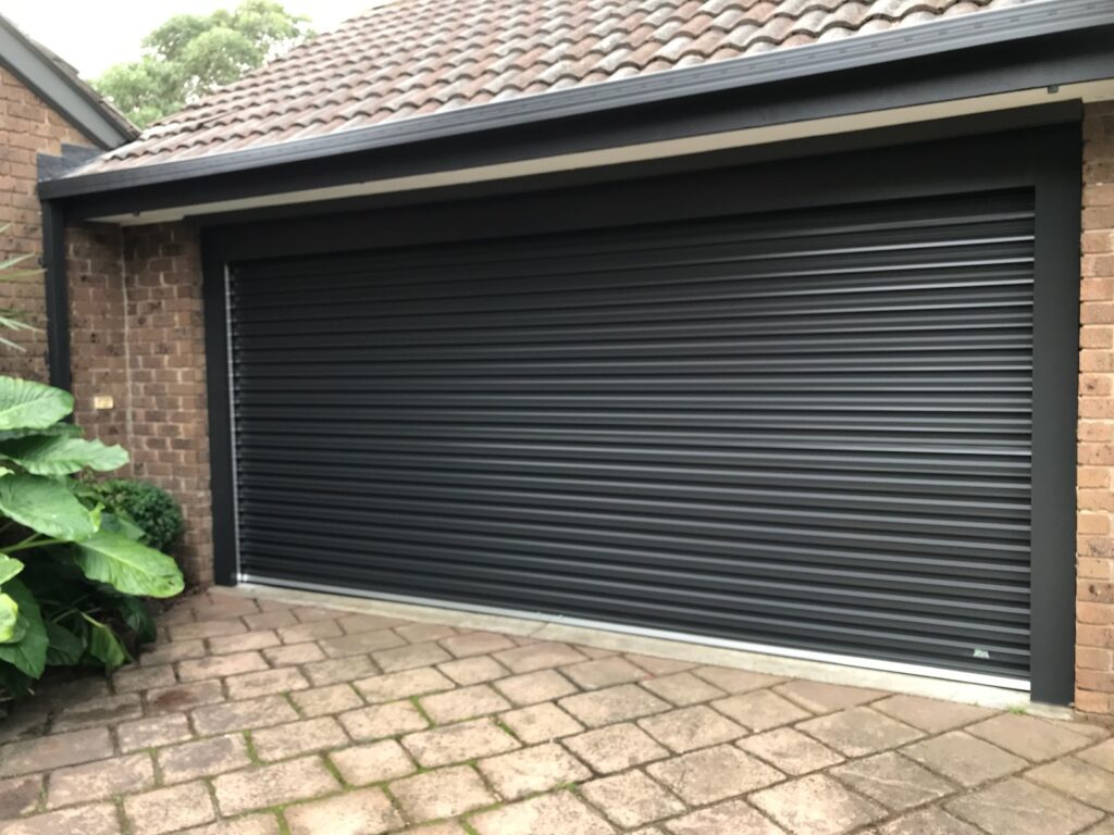 roller garage door with 2 metal posts, and overhead fascia in monument for our customer in Dingley